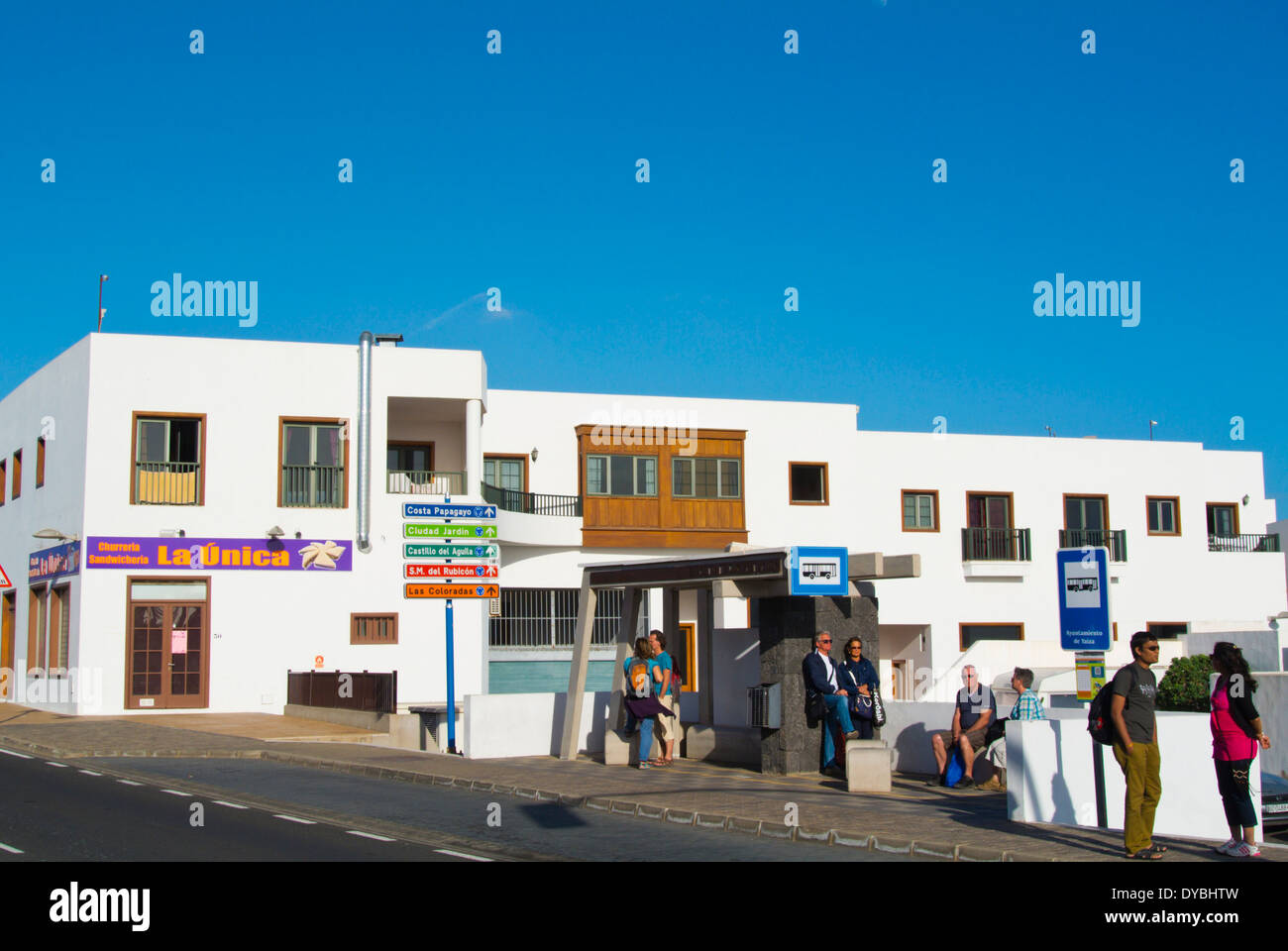 People waiting for bus outside the bus station, Playa Blanca, Lanzarote, Canary Islands, Spain, Europe Stock Photo