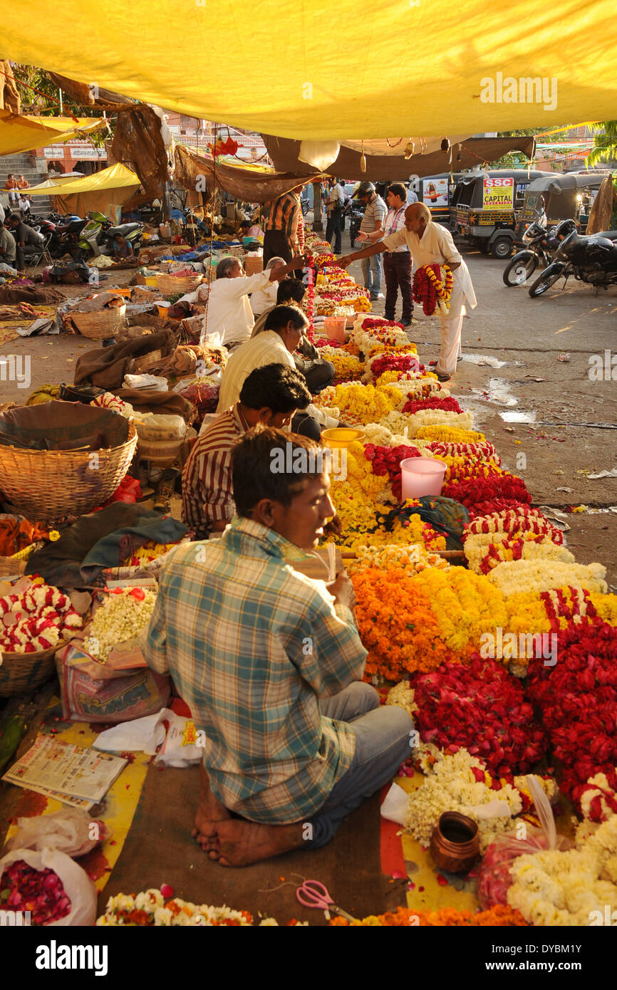 Agra, India. April 10th 2014. A backlit market selling flowers for religious use. Stock Photo