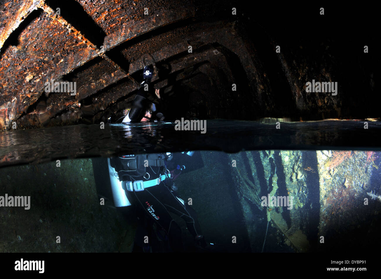 Diver surfaces in internal air chamber, Cedar Pride shipwreck, Gulf of Aqaba, Red Sea, Jordan Stock Photo