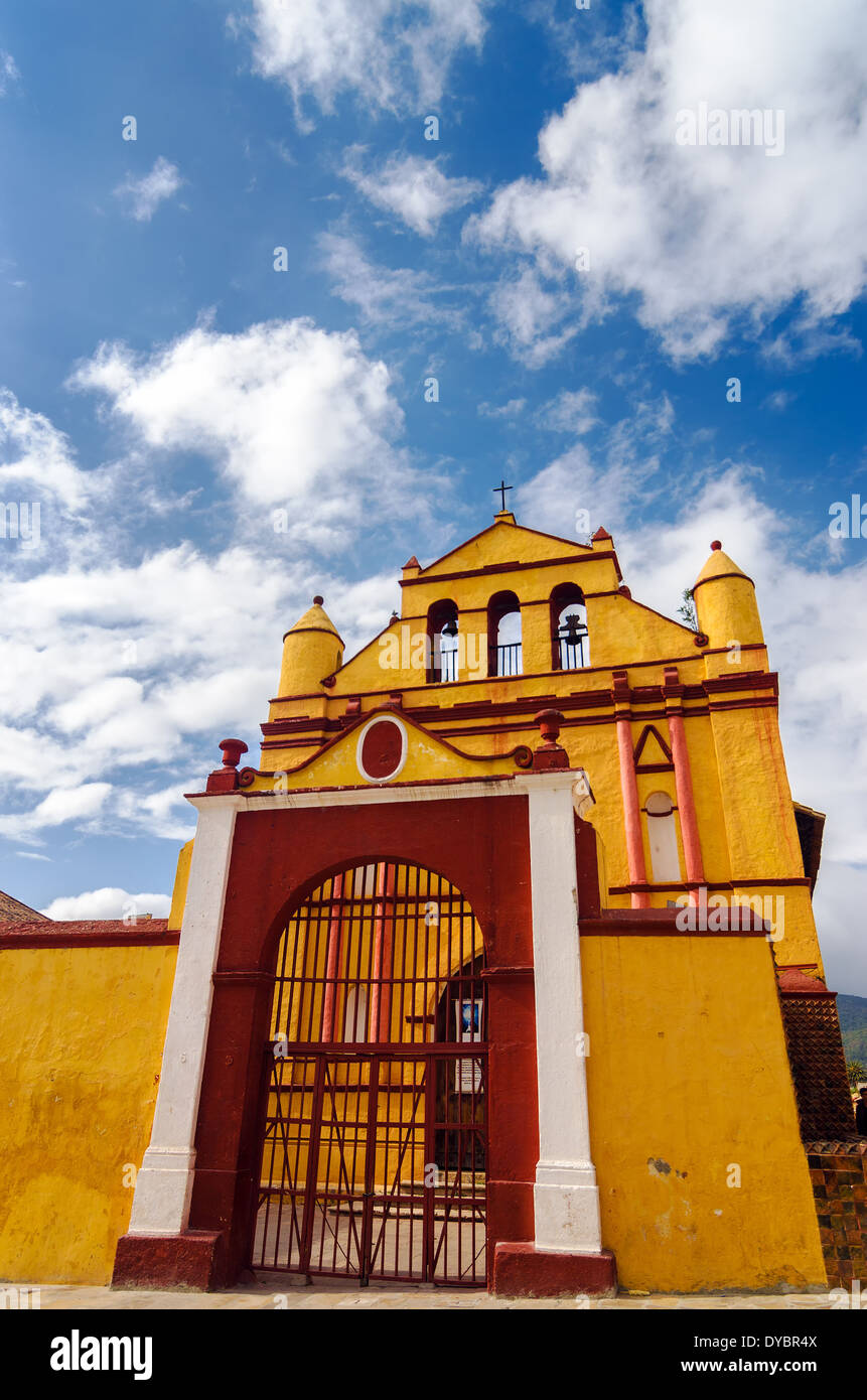 Yellow colonial church with beautiful blue sky in San Cristobal de las Casas in Chiapas, Mexico Stock Photo