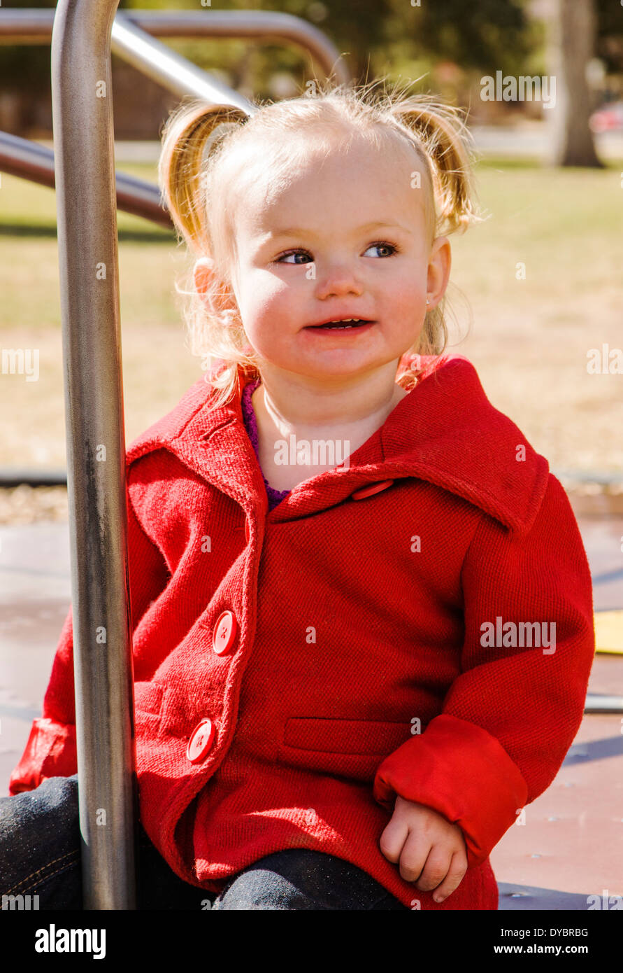 Cute, adorable 16 month little girl playing on a park playground Stock Photo