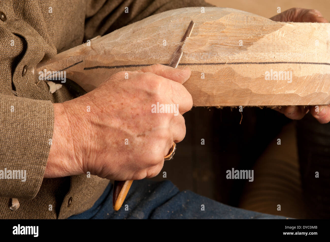 Hand carving a wooden bird decoy Stock Photo