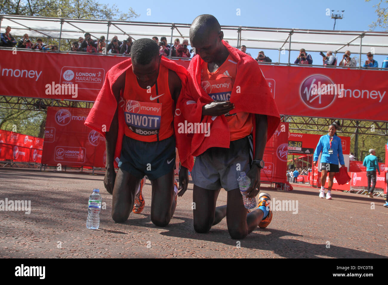 London, UK. 13th Apr, 2014. Stanley Biwott and Wilson Kipsang in prayer after the finish of the 34th London Marathon. They came second and first respectively. Credit:  David Mbiyu/Alamy Live News Stock Photo