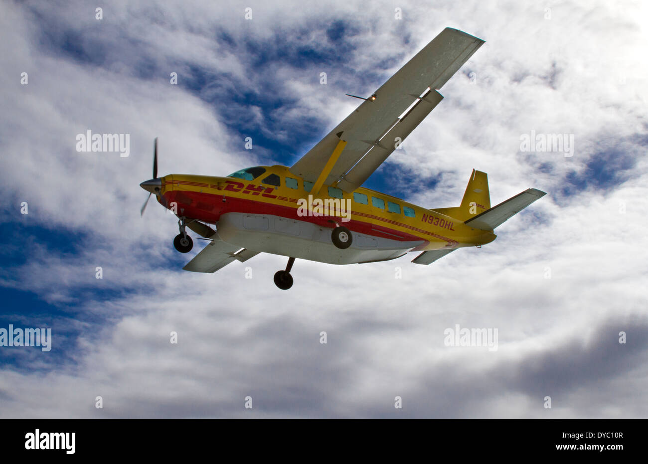 DHL smal plane landing at airport in St Maarten Stock Photo