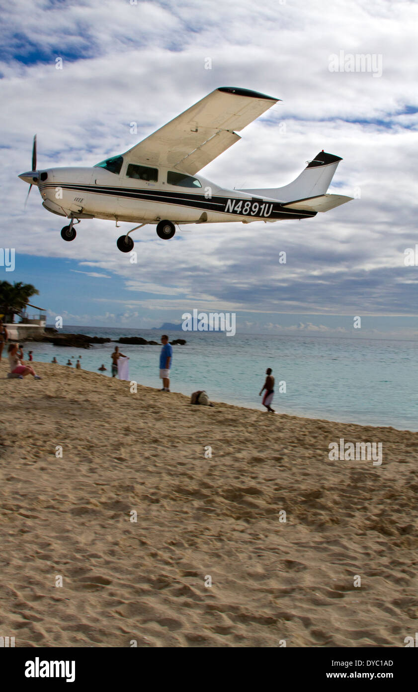 Small plane landing at airport in St Maarten Stock Photo