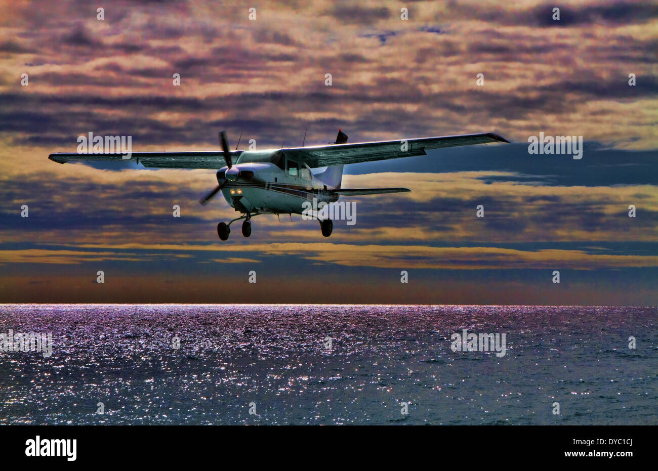 Small plane landing at airport in St Maarten Stock Photo