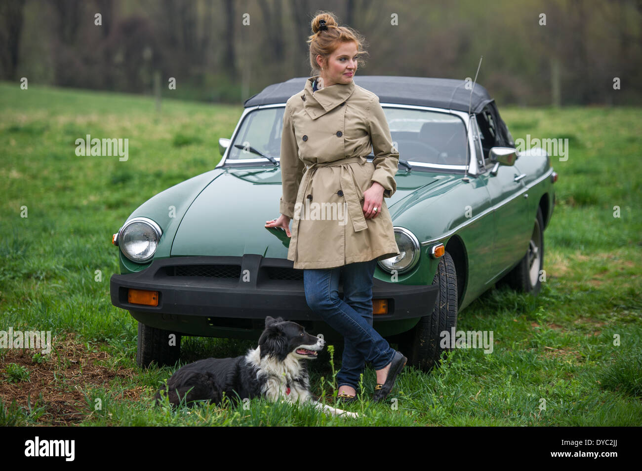 Woman with dog next to classic british sports car Stock Photo