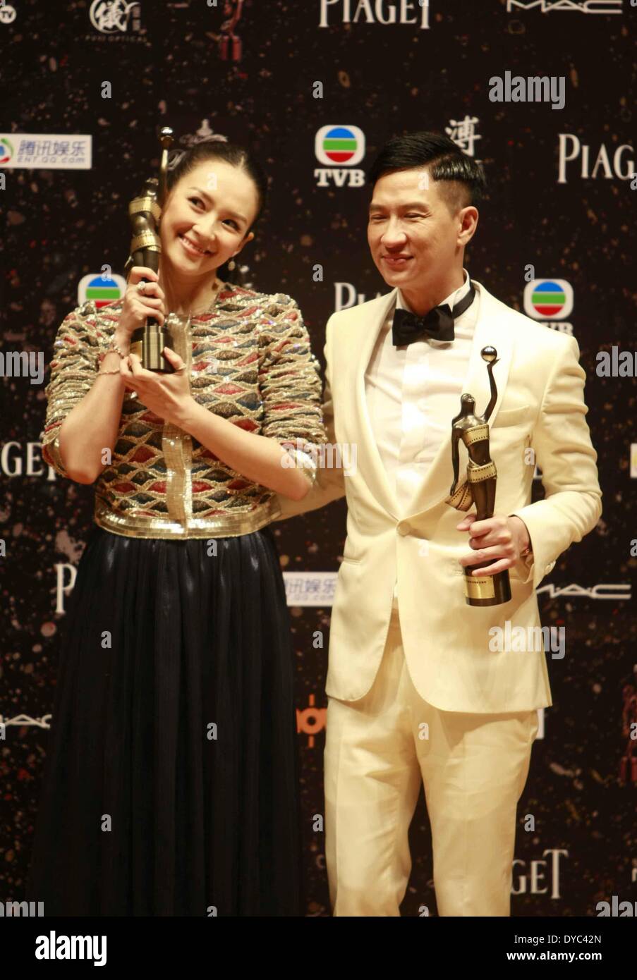 Hong Kong, China. 13th Apr, 2014. Zhang Ziyi (L), winner of the Best Actress award for her performance in the movie 'The Grandmaster', and Nick Cheung, winner of the Best Actor award for his performance in the movie 'Unbeatable', show their trophies at the presentation ceremony of the 33rd Hong Kong Film Awards (HKFA) in Hong Kong, south China, April 13, 2014. © Cai Fangya/Xinhua/Alamy Live News Stock Photo