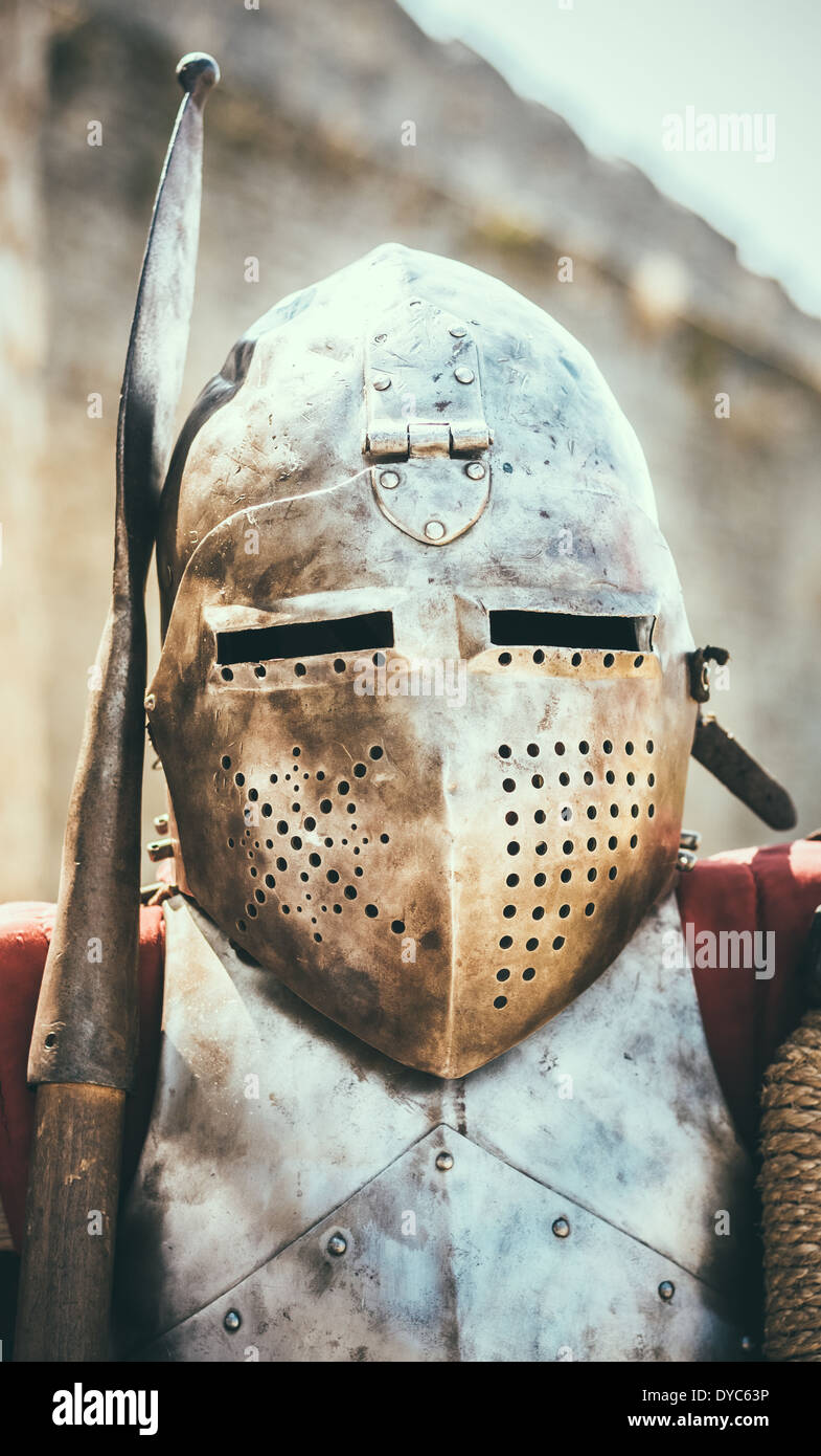 Medieval Knight In Helmet On Ancient Wall Background Stock Photo