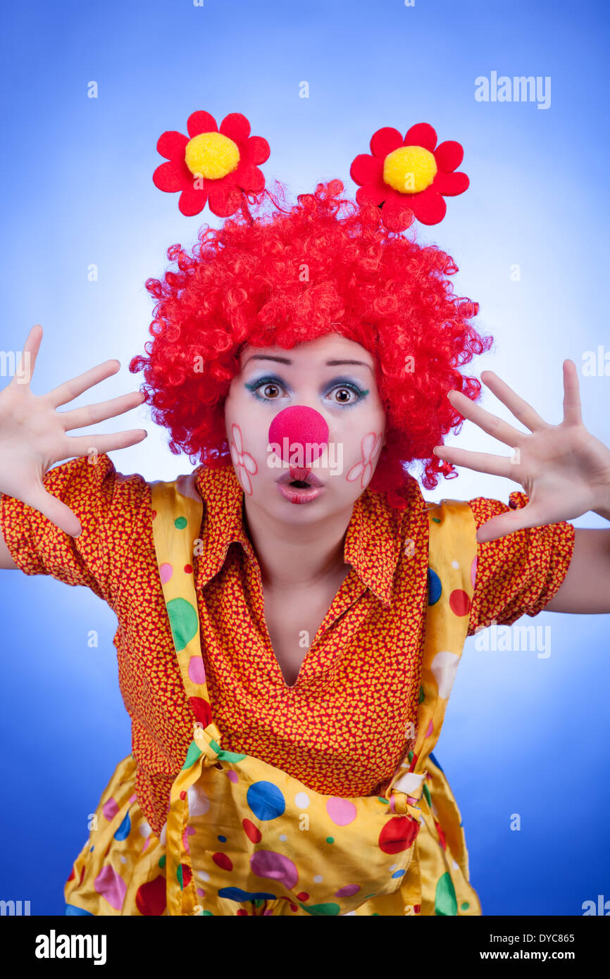 Clown woman on blue background studio shooting. Professional lighting Stock Photo
