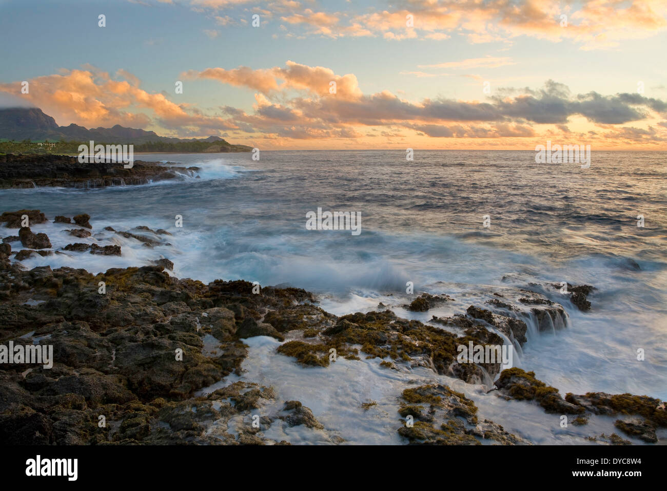 The sea cliffs and surf at sunrise near Shipwreck Beach in Poipu, Kauai, Hawaii. Winter Stock Photo