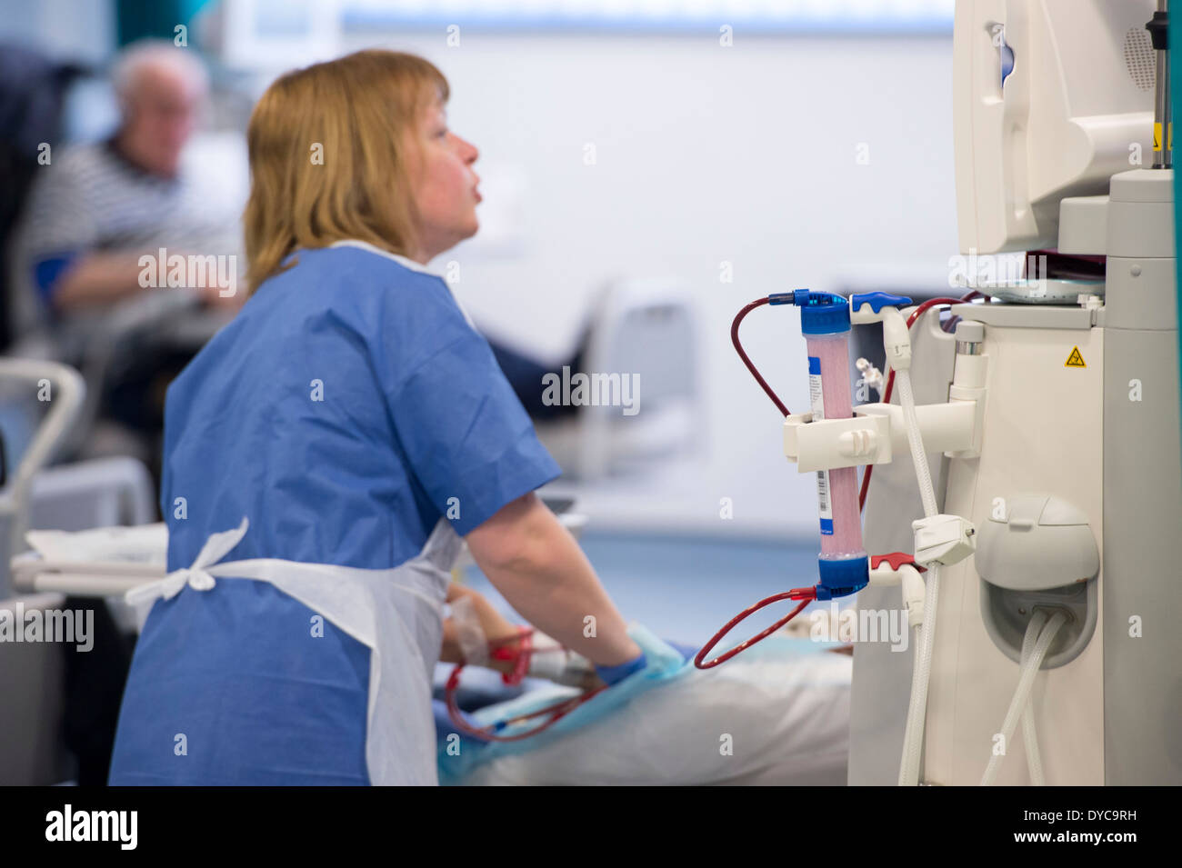 A nurse with a patient who is undergoing treatment for kidney disease on a kidney dialysis machine at a hospital Stock Photo