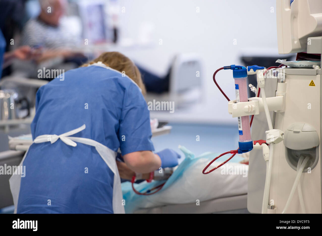 A nurse with a patient who is undergoing treatment for kidney disease on a kidney dialysis machine at a hospital Stock Photo