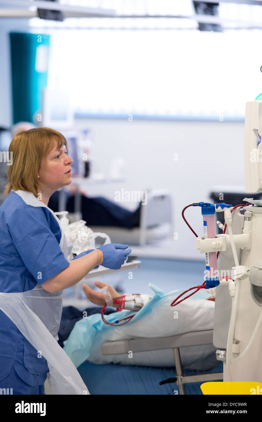 A nurse with a patient who is undergoing treatment for kidney disease on a kidney dialysis machine at a hospital Stock Photo