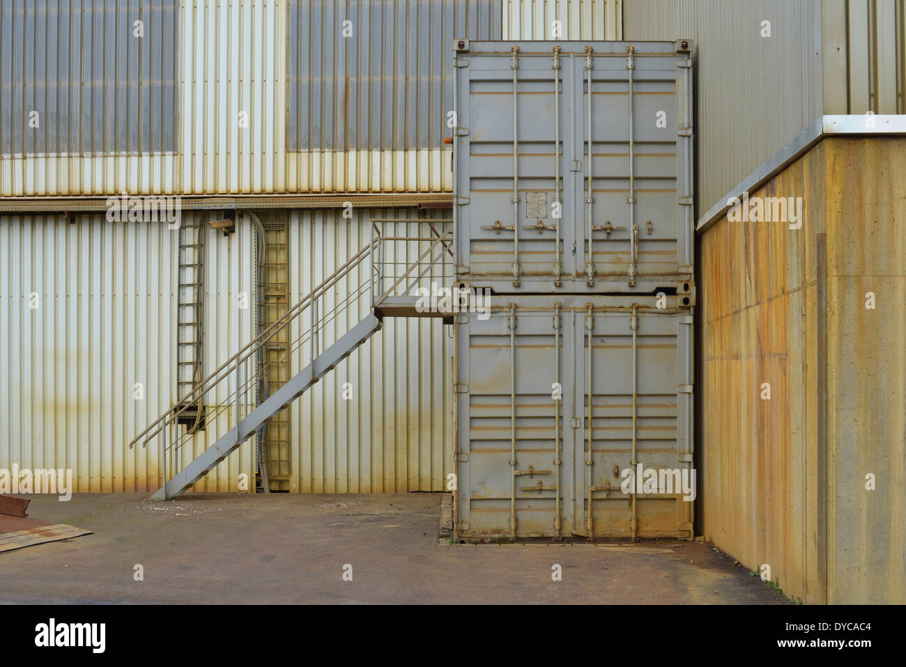Shipping containers being used for office or storage space in an industrial setting. Stock Photo