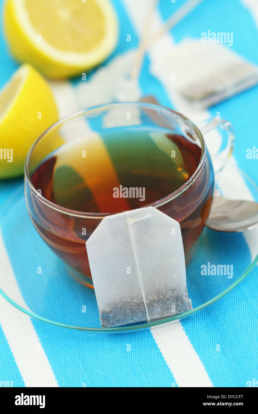 Tea bag leaning against cup of tea Stock Photo