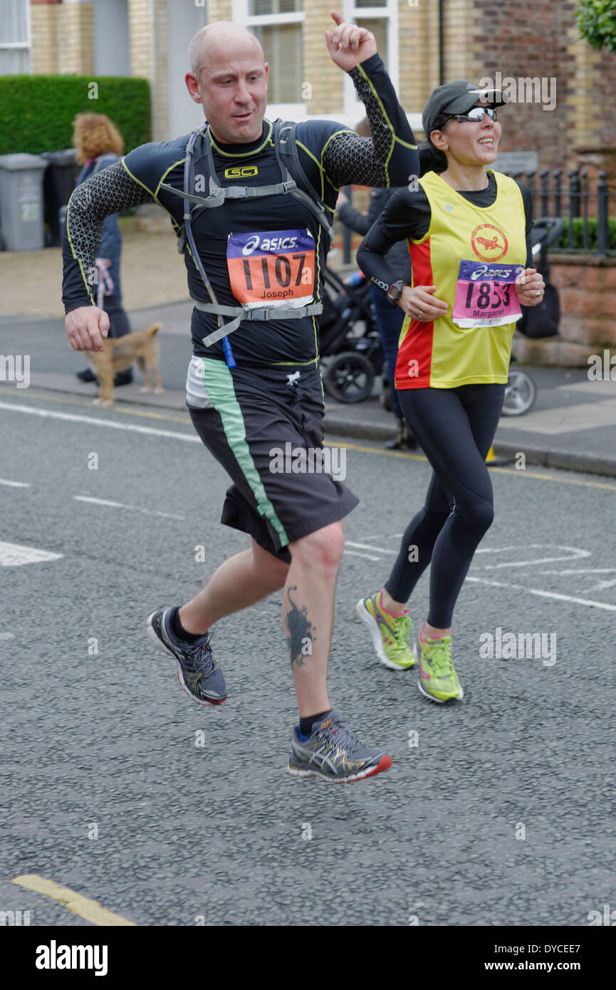 Manchester Marathon 2014 A runner "plays to the gallery" ! Stock