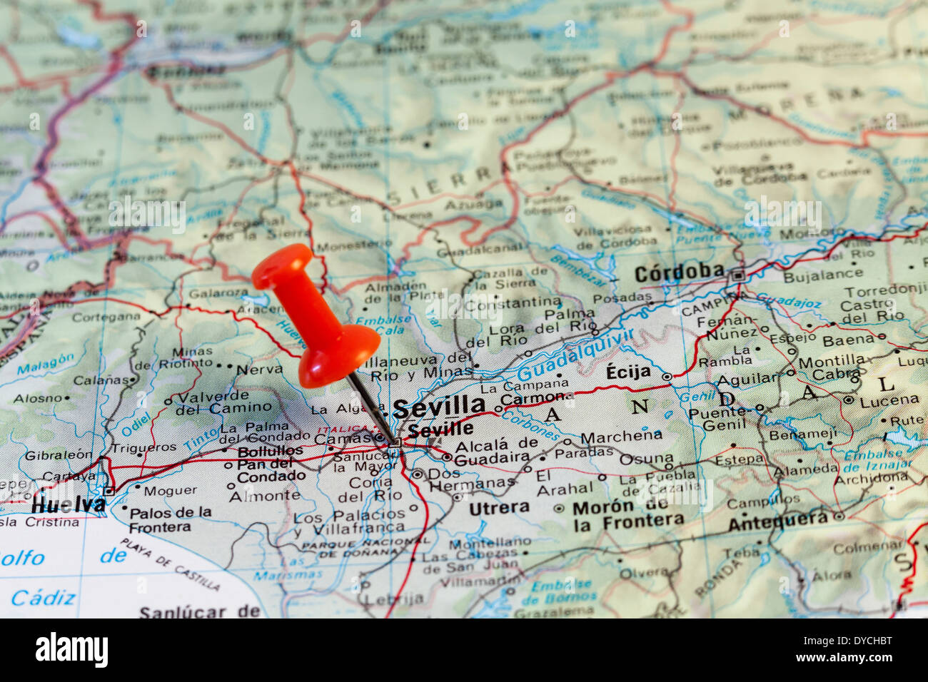 Red map pin pointing on map to the city of Seville. Stock Photo