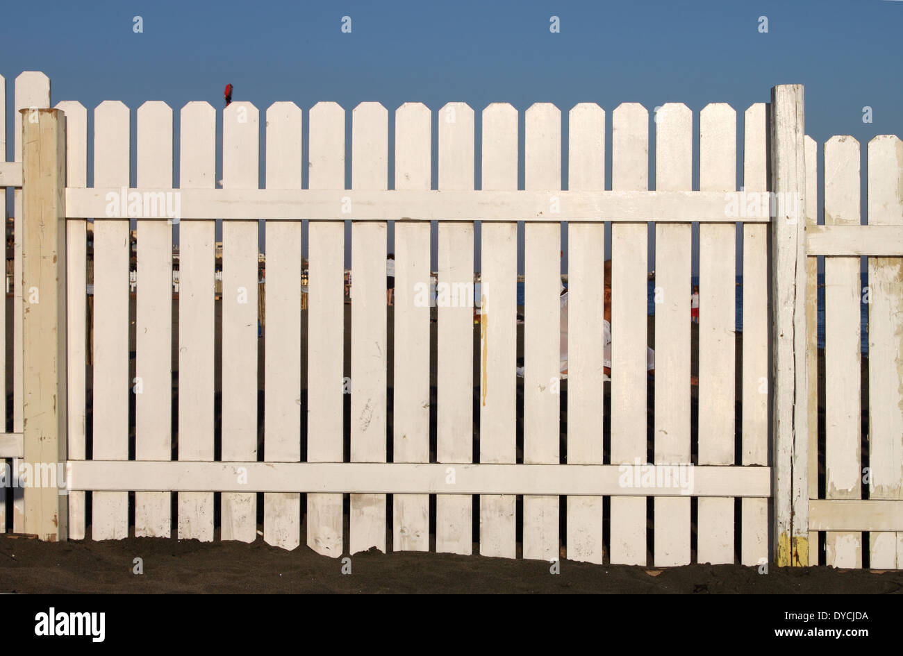 A wooden white fence on the beach on a blue sky background Stock Photo ...