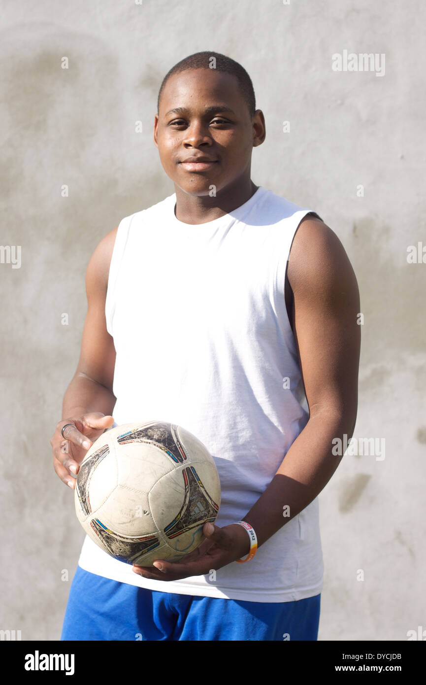 Portrait of young black male holding a football. Stock Photo