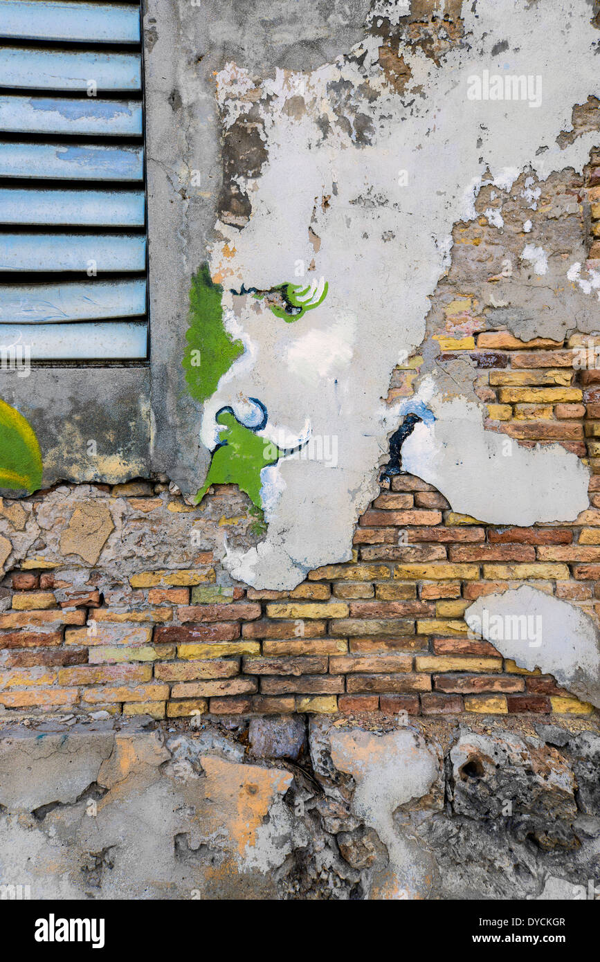 Patchwork made into a face on a crumbling building in Fredricksted St. Croix, U. S. Virgin Islands. Stock Photo