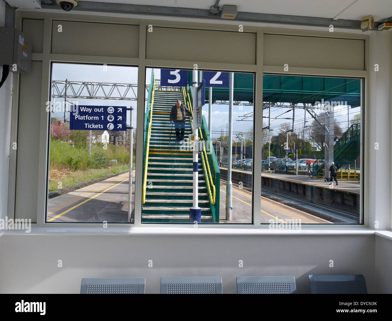 Senior man struggling on railway station stairs in Sandbach Cheshire UK Stock Photo
