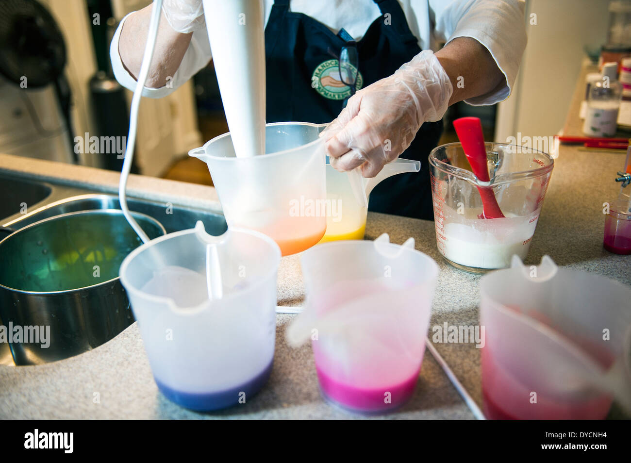 A woman mixing colors for handcrafted soap Stock Photo