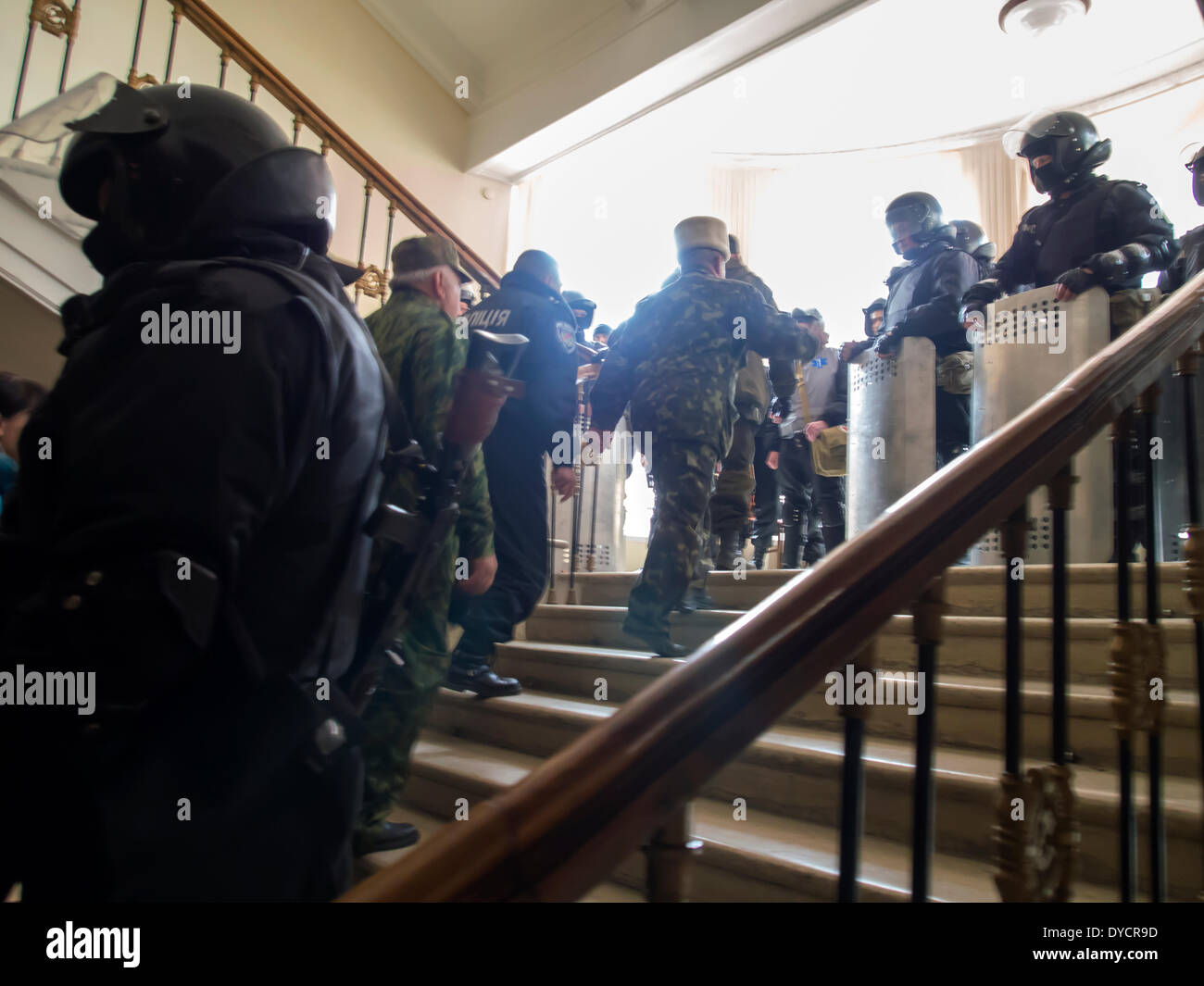 Lugansk, Ukraine. 14th Apr, 2014. UUkraine riot police officers guard an entrance of the Ukrainian regional administration building to prevent Pro-Russian activists attacking it --- Armed pro-Russian militants holed up in the Ukrainian regional office of the Security Service in Lugansk and refused to give up their arms and vowed to fight off any efforts by the state to dislodge them. Credit:  Igor Golovnov/Alamy Live News Stock Photo