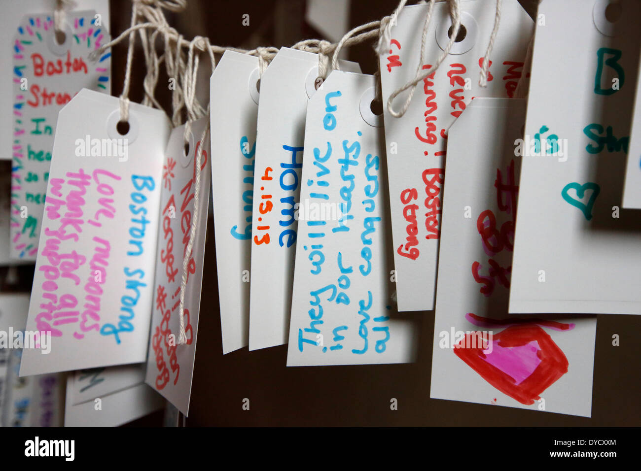 Boston, Massachusetts, USA, 14th April 2014. Tags with personal messages from visitors to the Boston Marathon Memorial exhibit hang from a tree in the Boston Public Library. Tuesday marks the one-year anniversary of the Boston Marathon bombings. Stock Photo