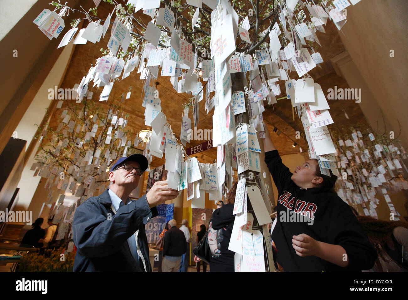 Boston, Massachusetts, USA, 14th April 2014. Visitors read personal messages left by visitors to the Boston Marathon Memorial exhibit in the Boston Public Library. Tuesday marks the one-year anniversary of the Boston Marathon bombings. Stock Photo