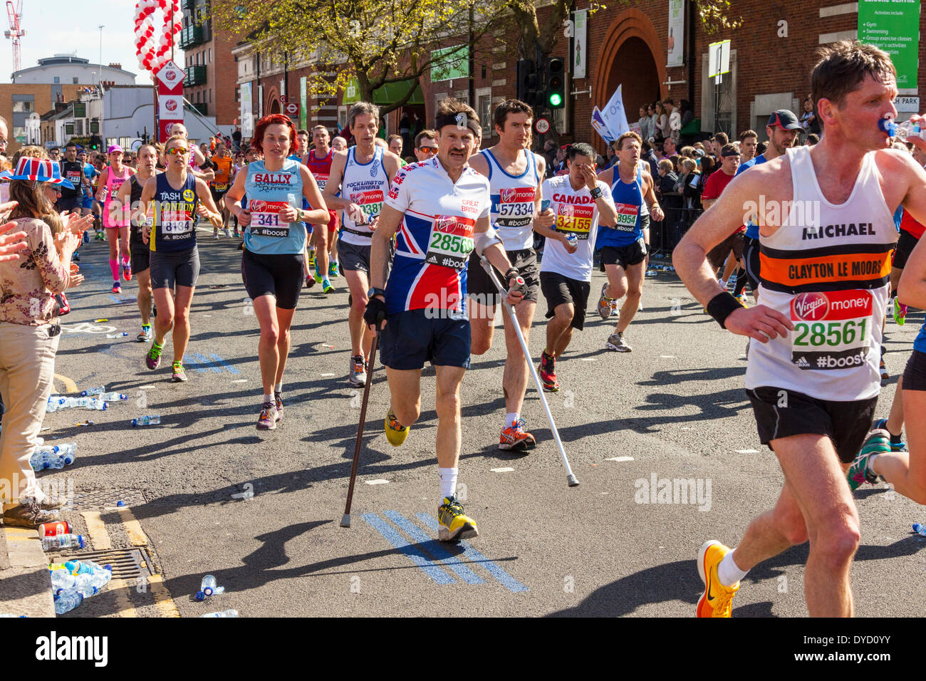 London UK. 13 April 2014 London Virgin Money Marathon including runner 28569 Hugh Culverhouse of Great Britain running with the help of crutches Credit:  John Henshall/Alamy Live News JMH6135 Stock Photo