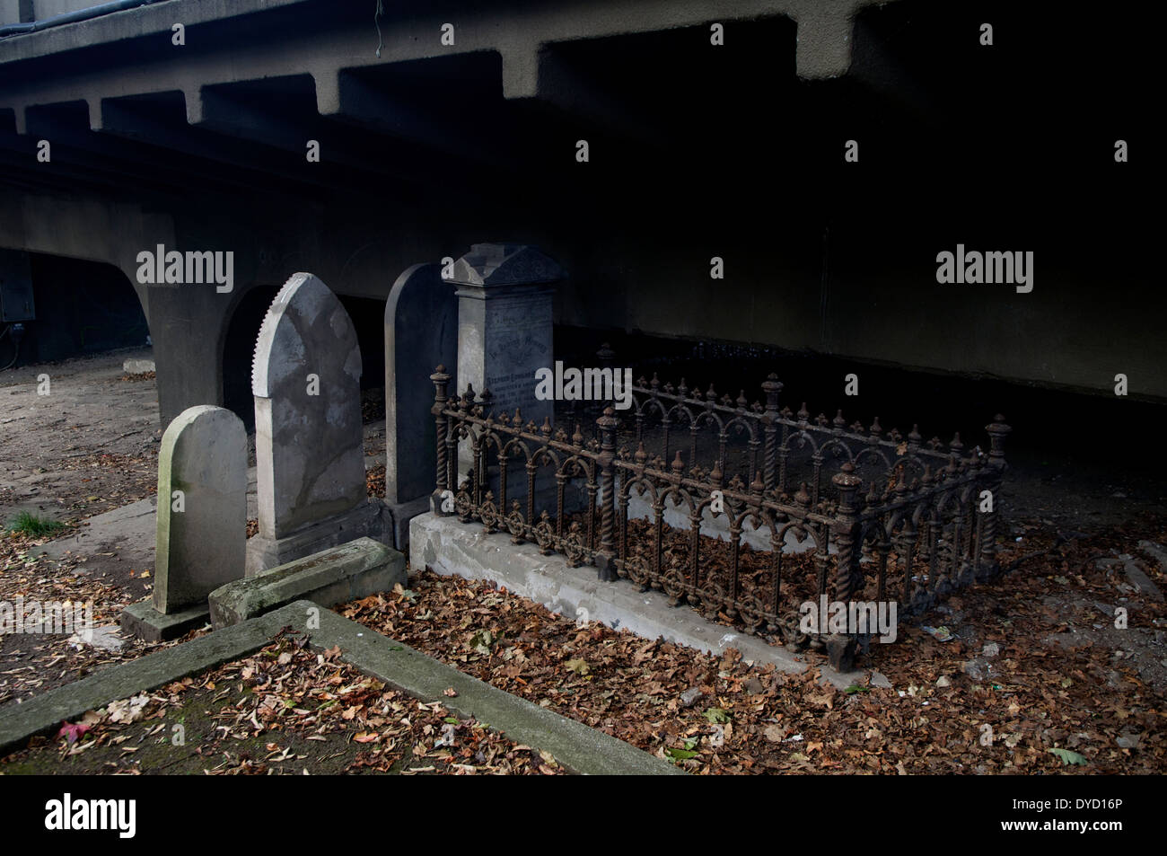 19thC headstones beneath a 20th century bridge in Grafton cemetery, Auckland New Zealand Stock