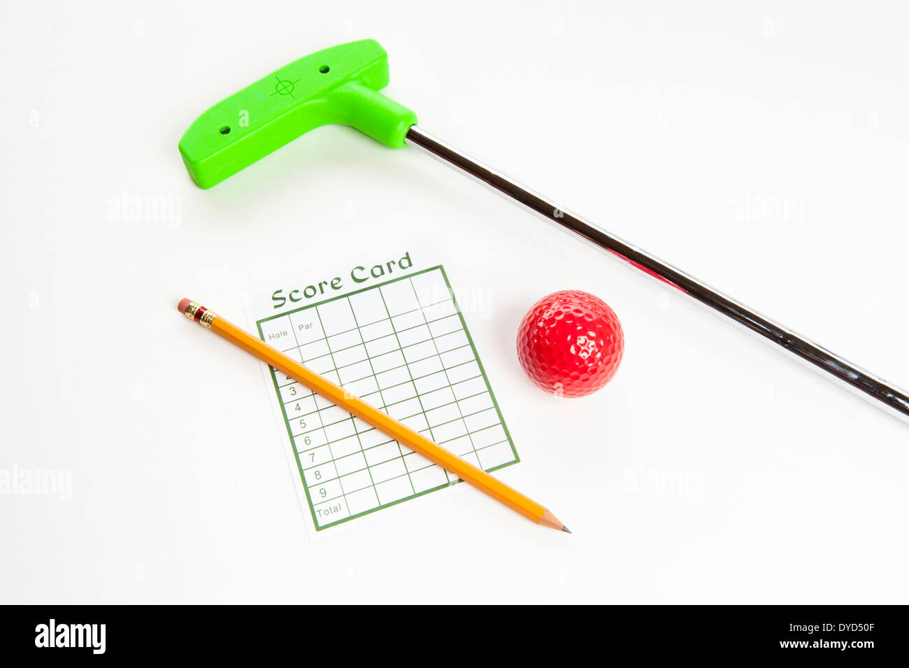 Green mini golf club with score card, pencil and red ball Stock Photo
