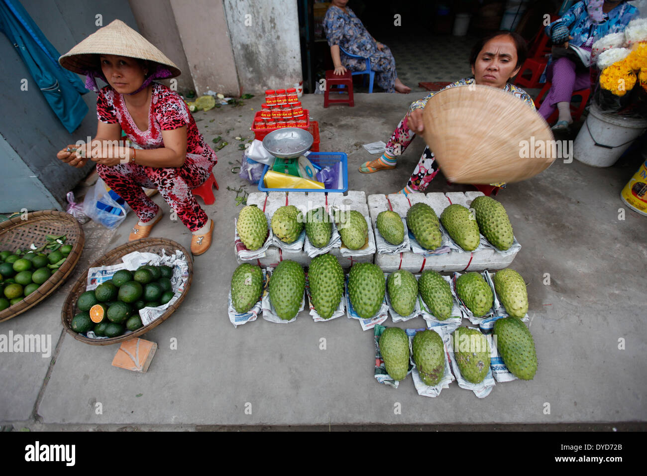 Women sell fruits at a market in Can Tho province, Vietnam Stock Photo