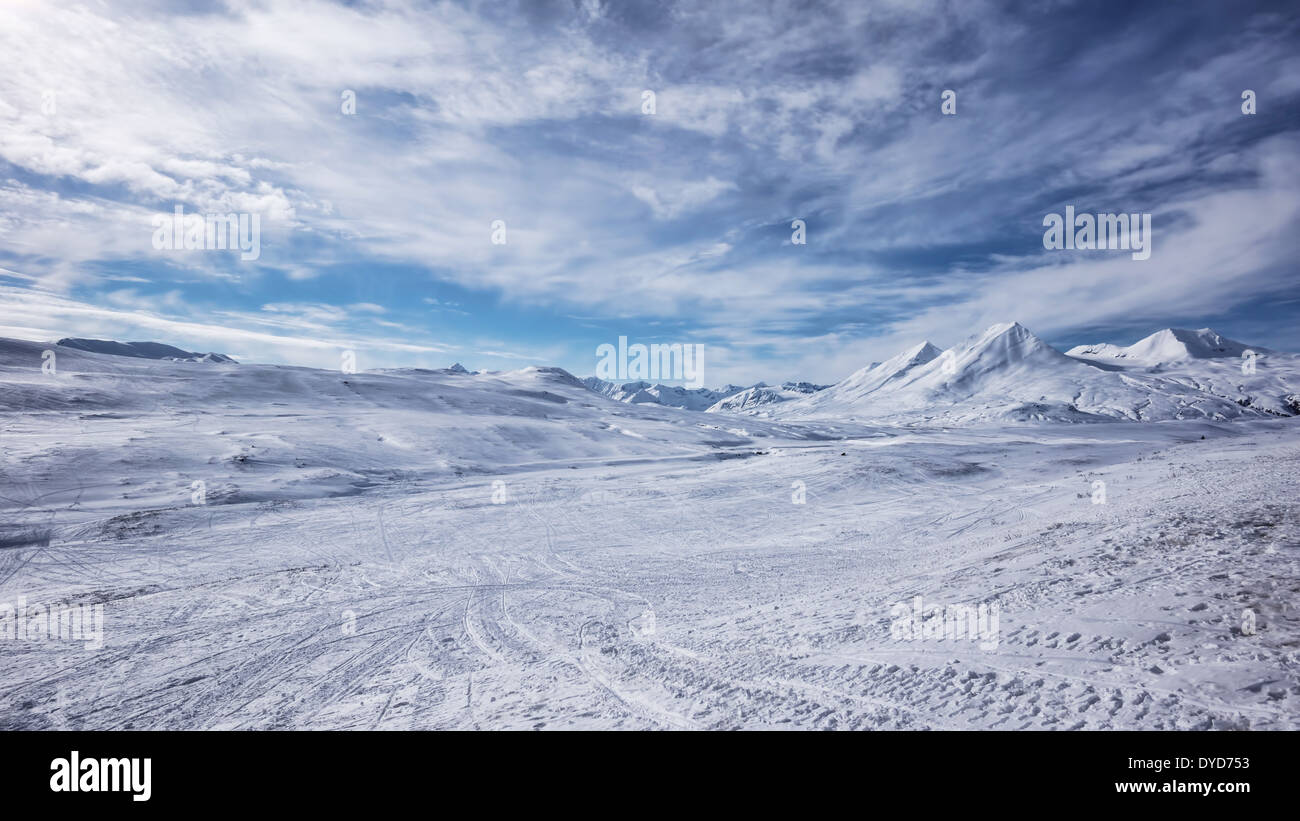 Tracks left by snowmobiles (snow machines) in Canada near the Haines Pass. Stock Photo