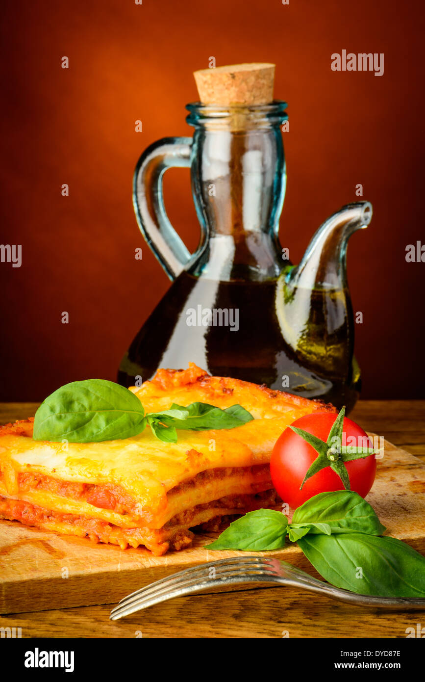traditional lasagna bolognese and bottle of olive oil Stock Photo