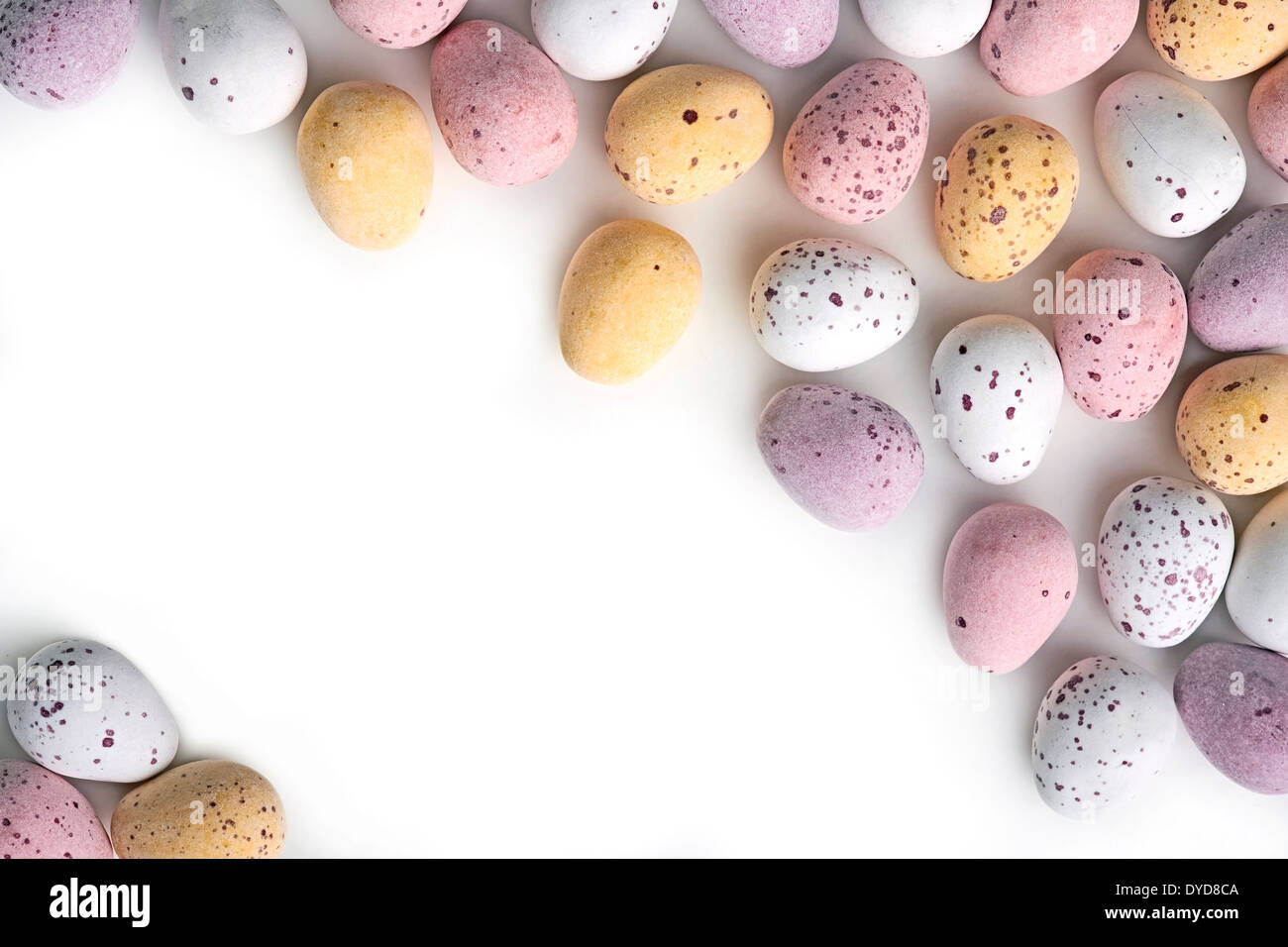 A selection of chocolate Easter Eggs with a candy crunchy shell on a white background. Stock Photo