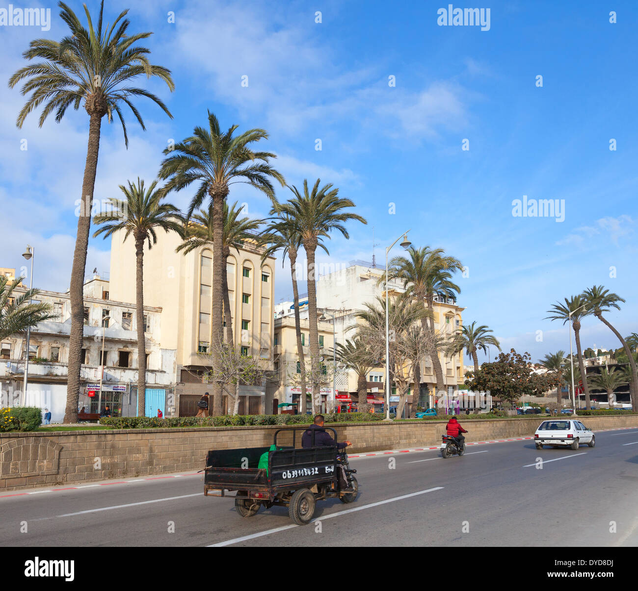 TANGIER, MOROCCO - MARCH 22, 2014: Old tricycle cargo bike with Arab driver rides on the street of  Tangier Stock Photo