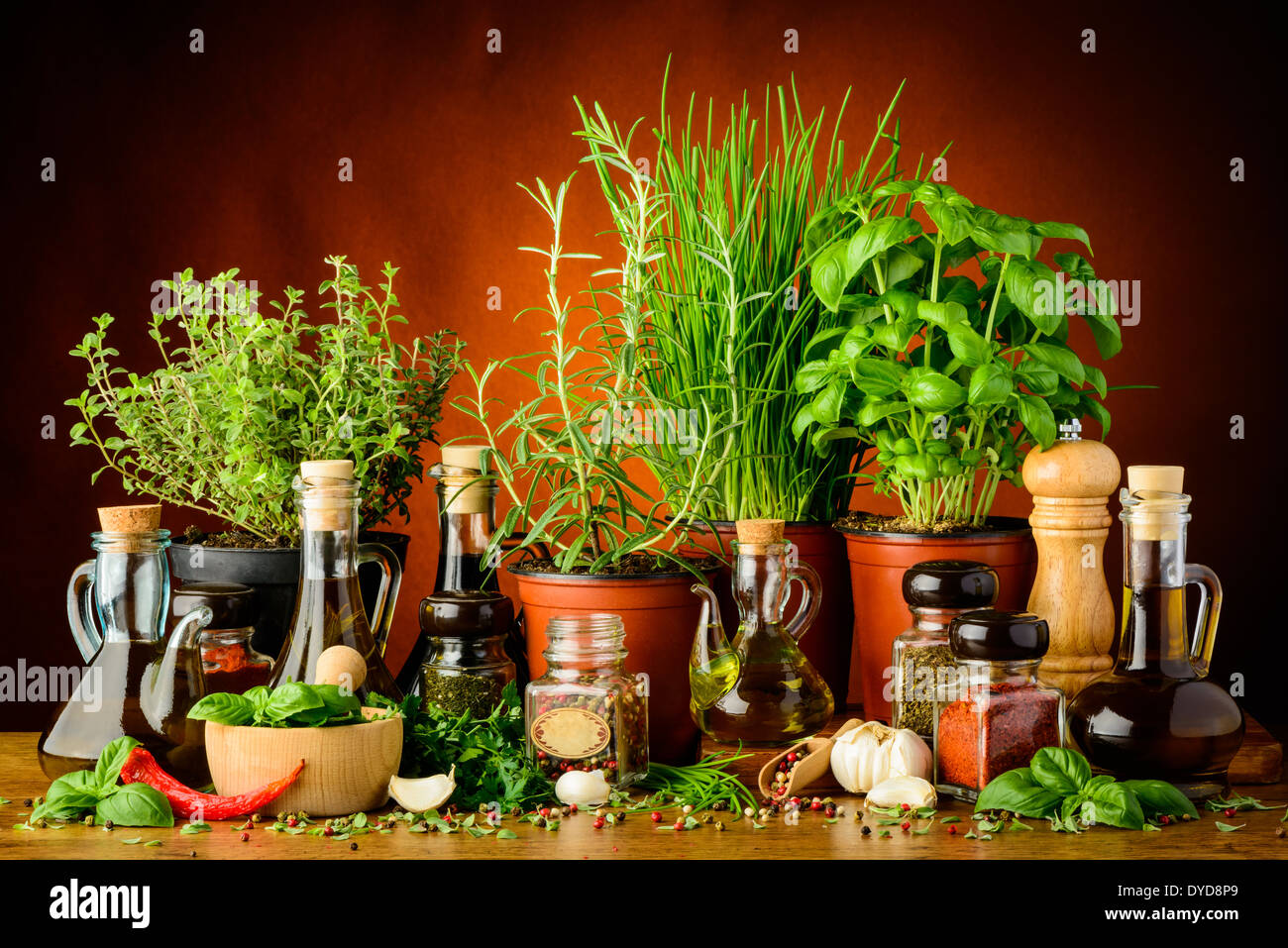still life with mediterranean herbs, spices and bottles of olive oil Stock Photo