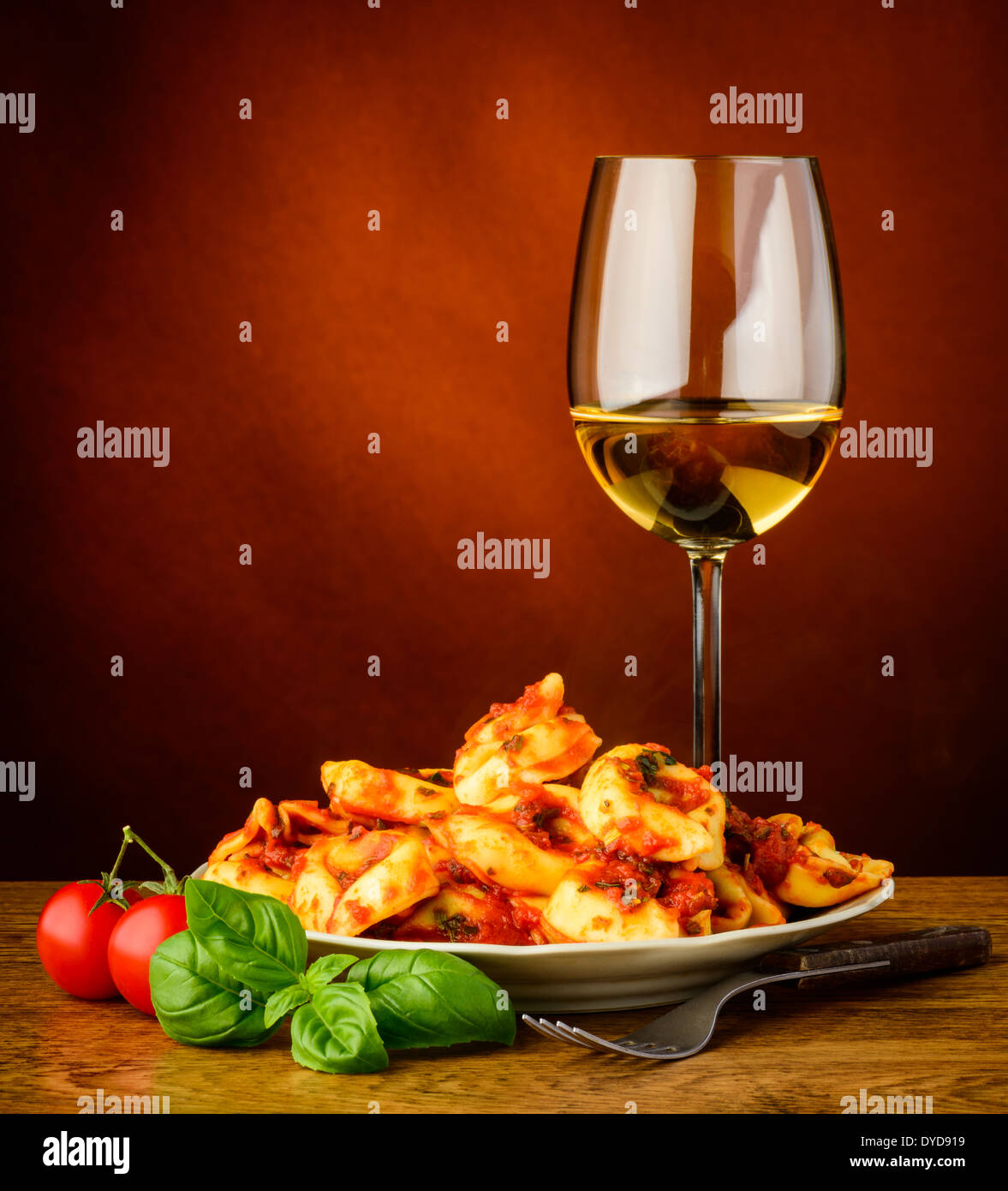 traditional italian tortellini pasta with tomato sauce, basil and white wine Stock Photo