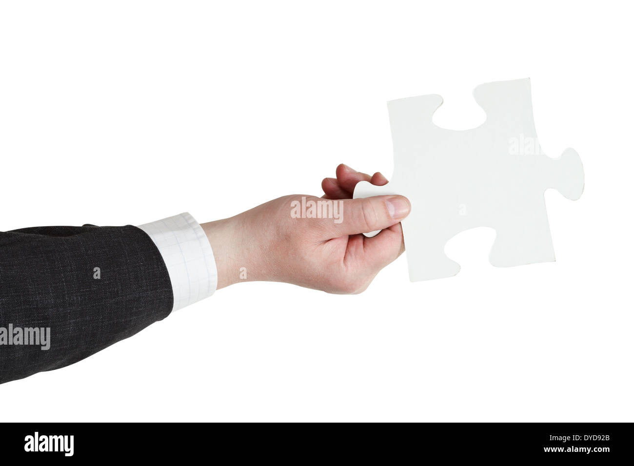 male hand holding big white paper puzzle piece isolated on white background Stock Photo