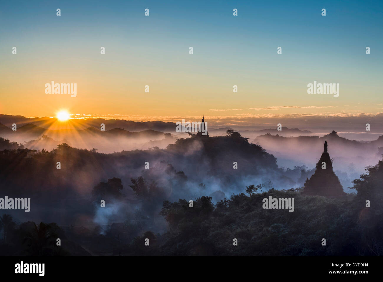 Pagodas surrounded by trees, at sunrise, in the mist, Mrauk U, Sittwe District, Rakhine State, Myanmar Stock Photo