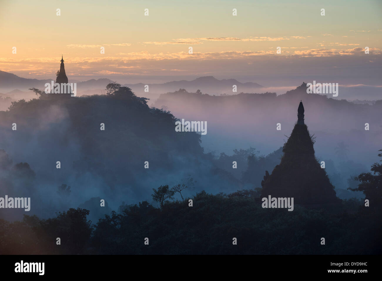 Pagodas surrounded by trees, in the mist, Mrauk U, Sittwe District, Rakhine State, Myanmar Stock Photo