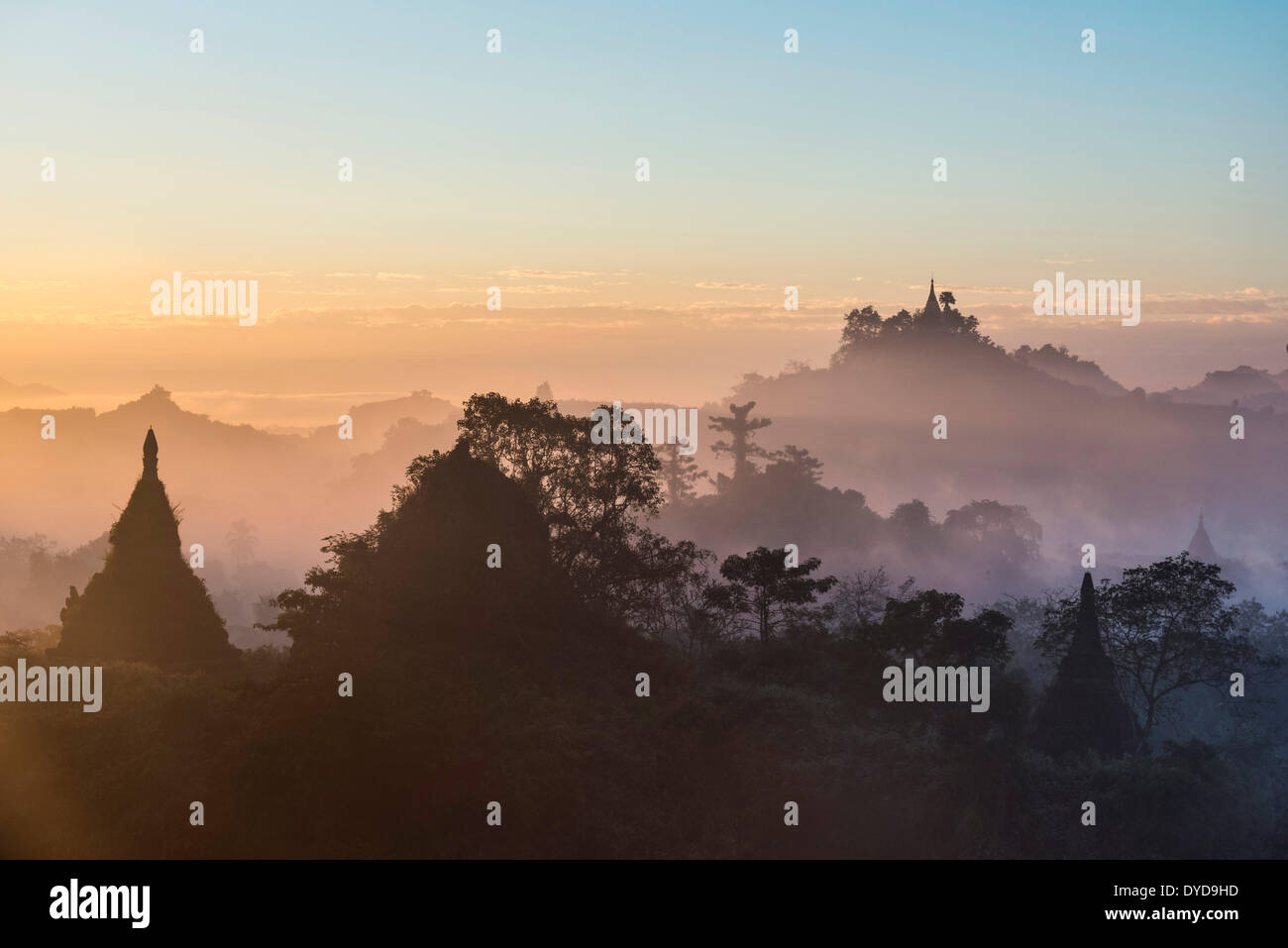 Pagodas surrounded by trees, in the mist, in the morning light, Mrauk U, Sittwe District, Rakhine State, Myanmar Stock Photo
