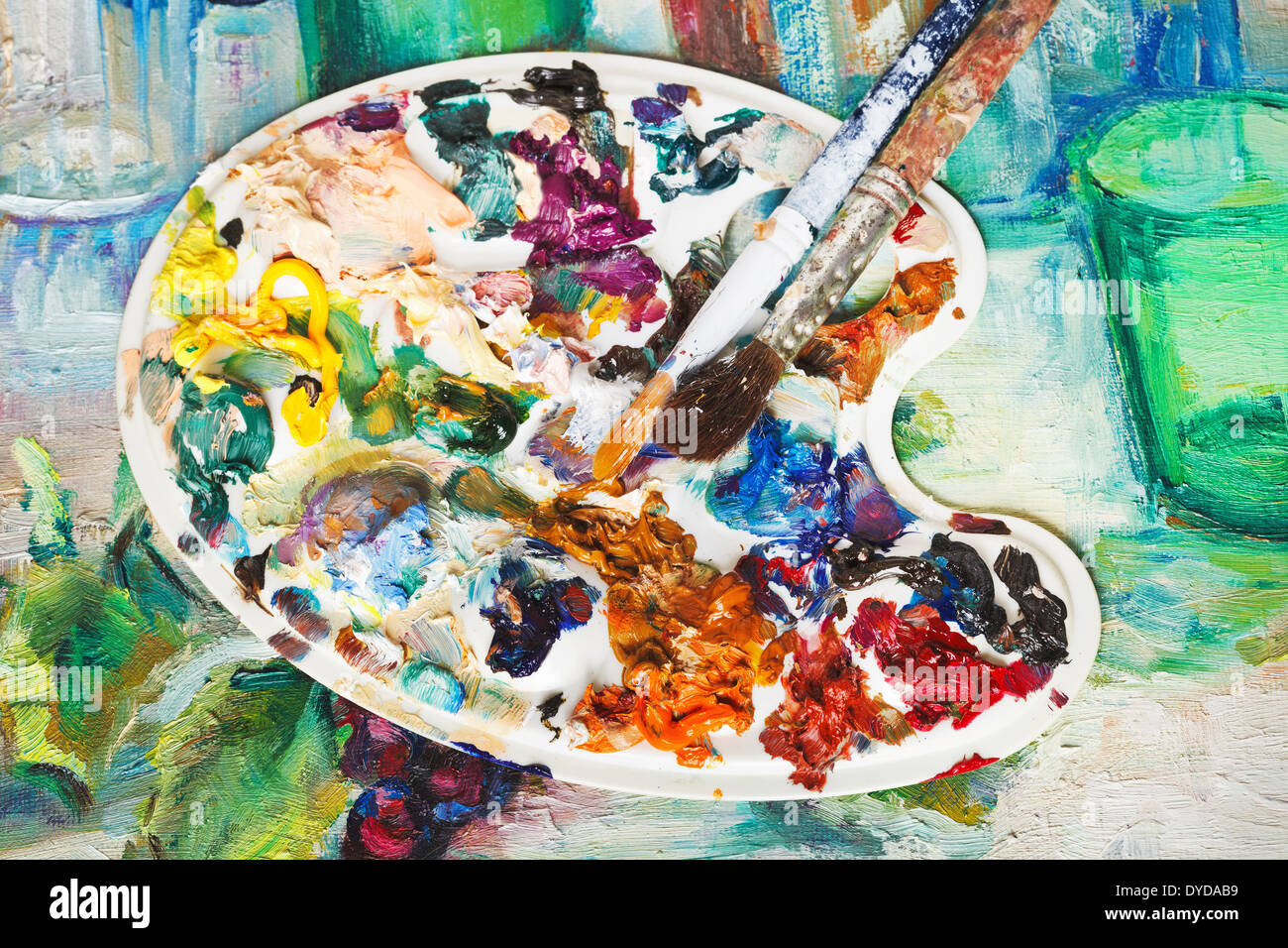 used artistic palette with oil paints and paintbrushes on picture canvas  Stock Photo - Alamy