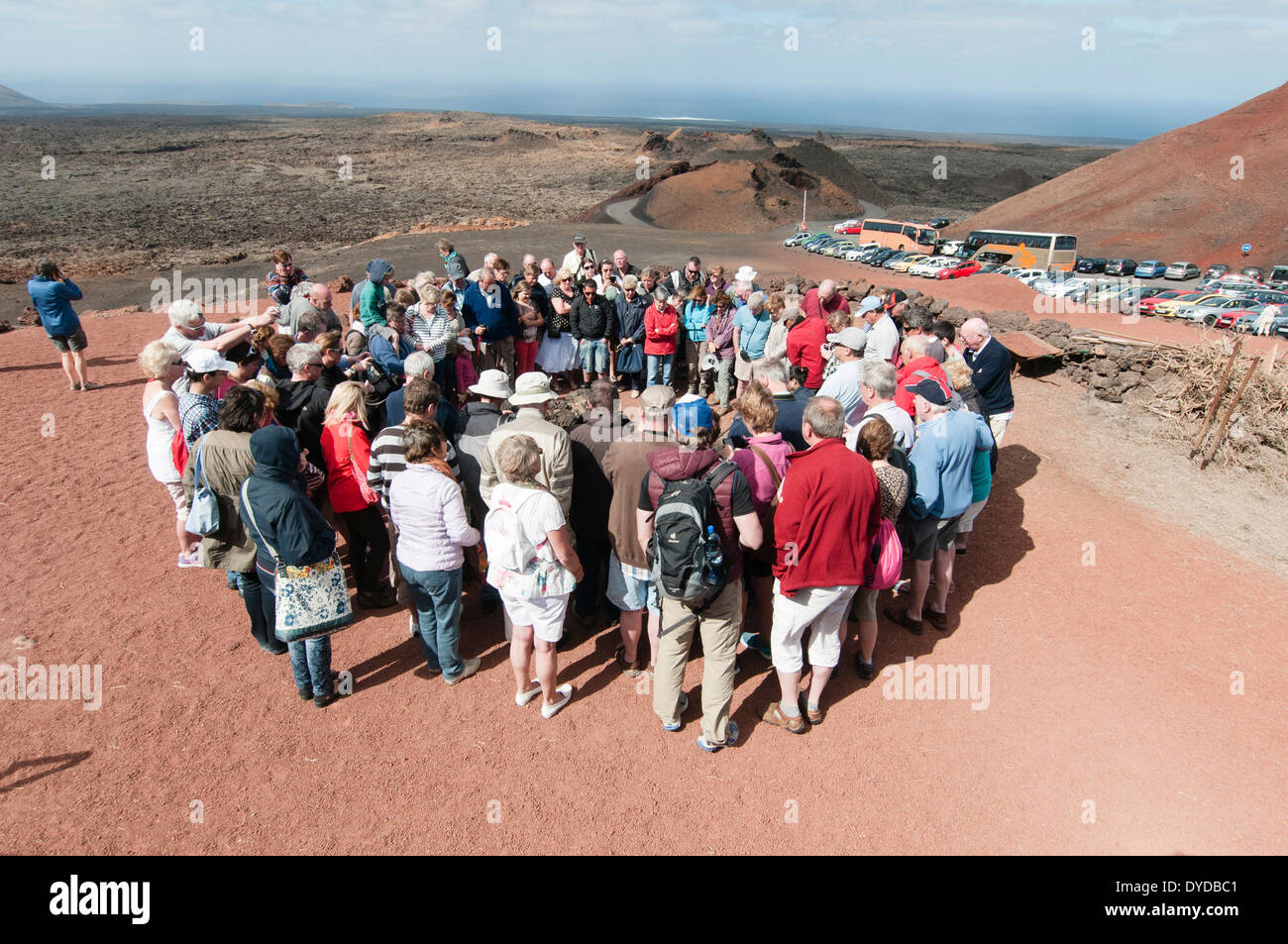 Lanzarote, Timanfaya National Park: A group of tourists watch a demonstration of the intense heat just below the surface. Stock Photo
