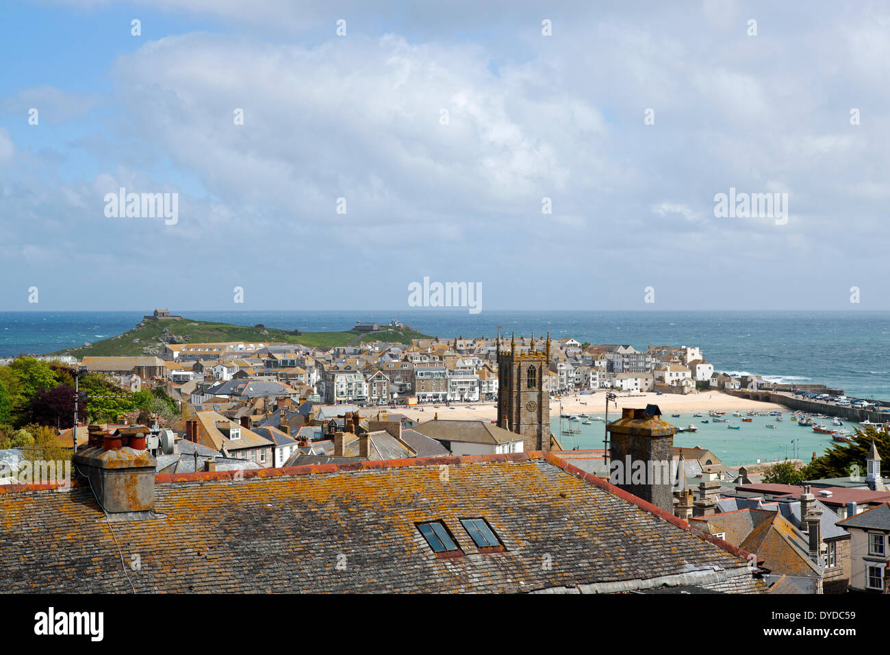 View over rooftops to the harbour and the Island in St Ives. Stock Photo