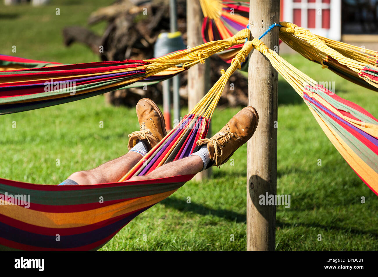 A man sleeping in a hammock at the Brownstock Festival in Essex. Stock Photo