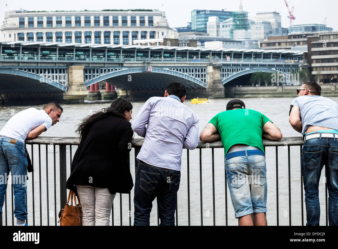 Friends looking at the River Thames from the Southbank. Stock Photo