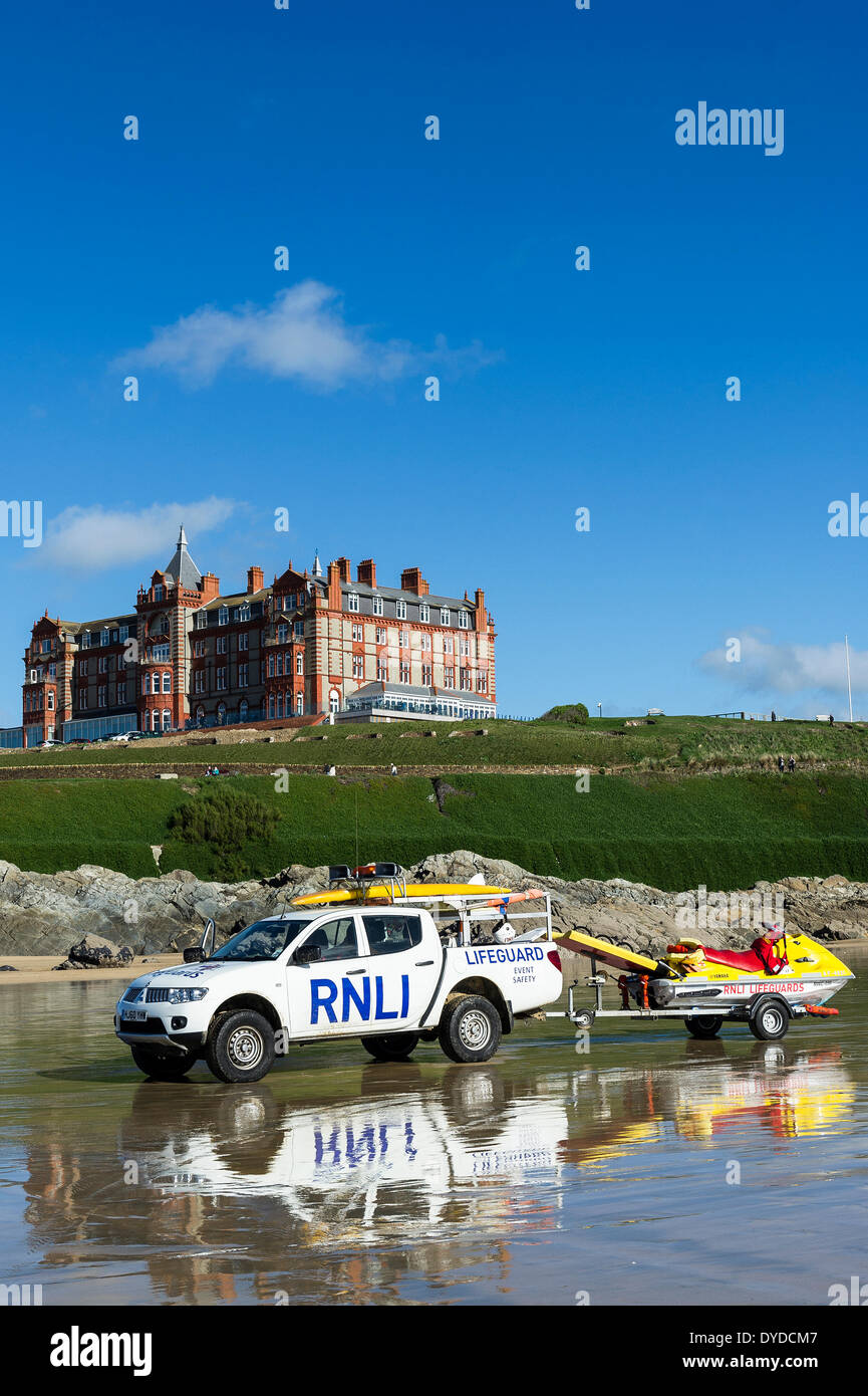 A RNLI Lifeguard truck and trailer parked on Fistral Beach with the Headland Hotel in the background. Stock Photo
